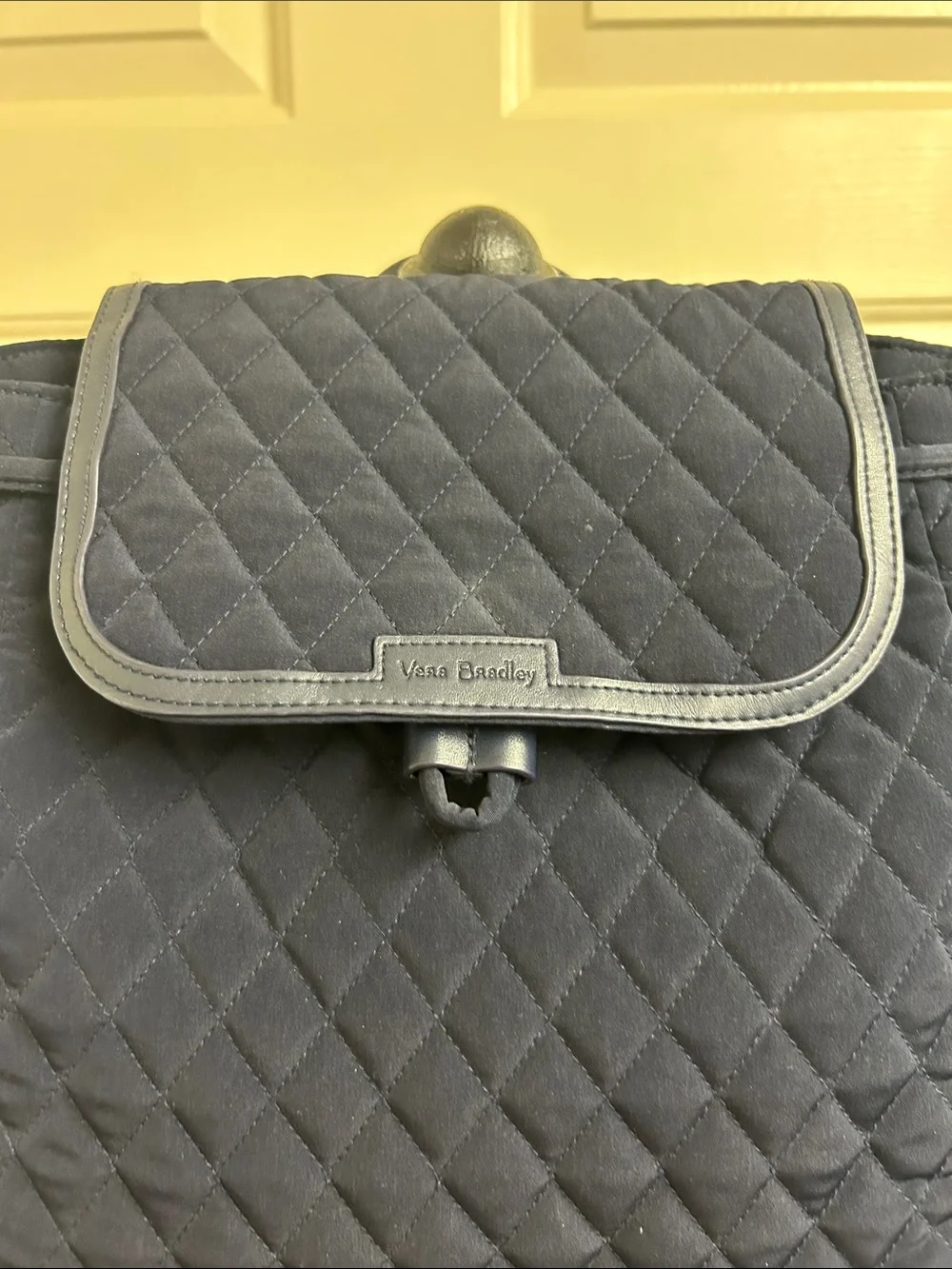 Vera Bradley quilted backpack in navy blue, diamond pattern a front flap closure